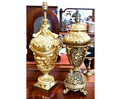 An ornate reticulated brass lamp-base, cast and mounted with mythical beasts and demons, on claw and ball feet, 43 cm, to/w a