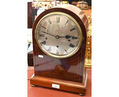 An Edwardian inlaid mahogany bracket clock with three-train movement striking and chiming on coiled gongs, 20 cm silvered dia