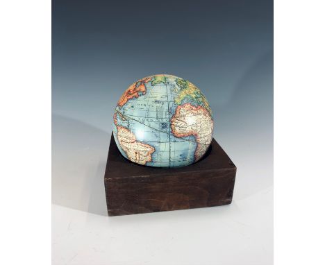 A globe with an associated wooden base, diameter of globe 13.5cm.Condition report: This modern reproduction is complete and h