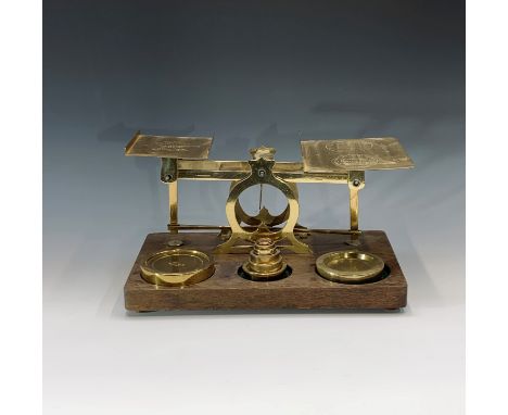 A set of large brass and oak parcel scales, late Victorian, by S Mordan &amp; Co, London, with a matched set of brass weights