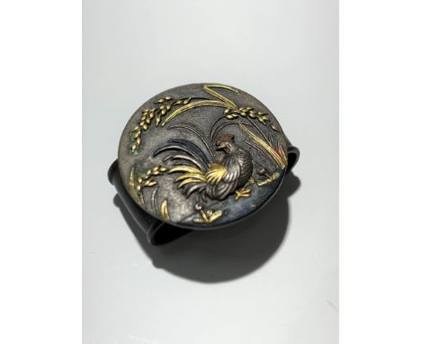 A Japanese shakudo copper alloy scarf slide decorated with a cockerel amongst grasses.Condition report: Wear is minimal
