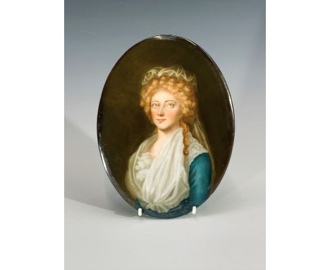 A late 19th century continental oval porcelain plaque, painted with a portrait of a young woman. Height 19cm.