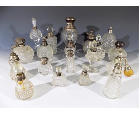 A collection of glass scent bottles and atomisers, many with hallmarked silver lids or collars. Height 18cm diminishing.