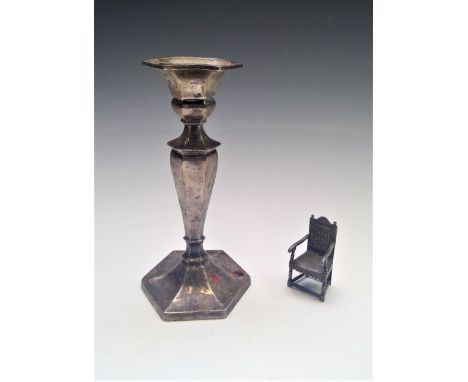 A filled silver candlestick and a Dutch silver miniature replica chair