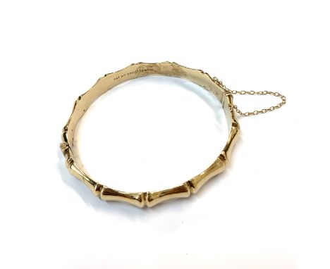 A 9ct gold bamboo moulded hinged bangle. 10gmCondition report: 60.8 x 55.7mm internal
