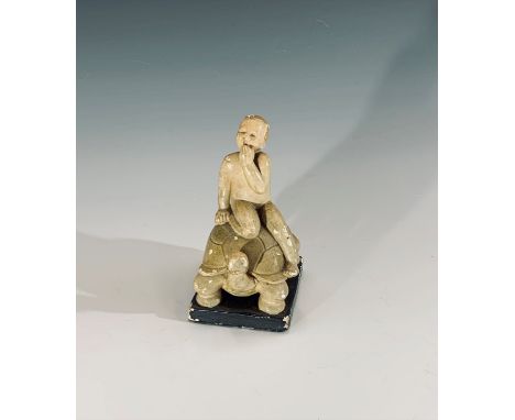 An Art Deco period painted plaster model of a child riding a large tortoise, James Bourlet paper label affixed to base. H12.5