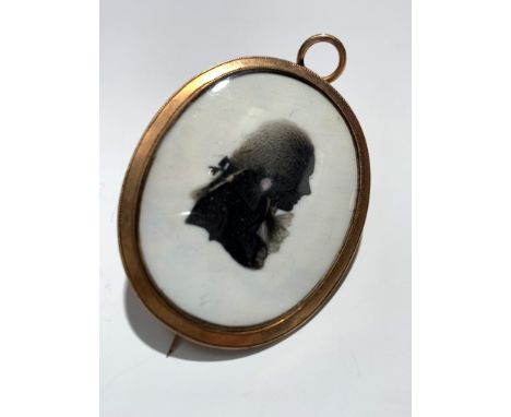 An 18th century gold or possibly gilt mounted mourning brooch/pendant (TO TEST) with a portrait of a young gentleman.