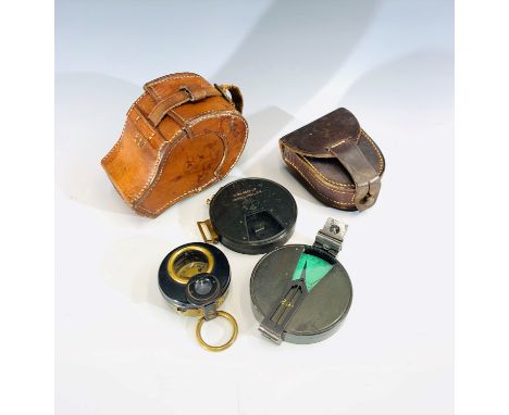 A military compass and a clinometer in a brown leather case, the clinometer by Hugh Rees Ltd, the compass by Hicks, Hatton Ga