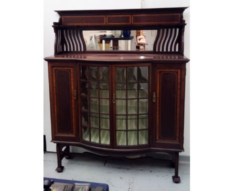 An Art Nouveau inlaid mahogany display cabinet, in the manner of Shapland and Petter, the mirror back above a pair of central