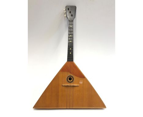 A Russian three-stringed balalaika, bearing interior label with printed Cyrillic script .