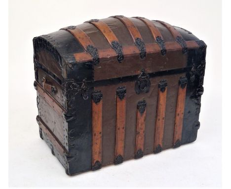 A wooden and metal bound domed top trunk, circa 1900, height 73cm, width 88cm, depth 54cm.