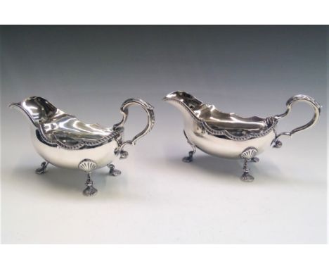 A pair of handsome silver sauce boats with gadrooned borders and shell feet in George II style with 1952 Coronation hallmarks
