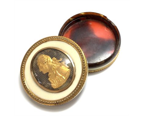 An 18th century European ivory snuff box mounted with gold beaded borders and tortoiseshell lined, the lid bears a gold relie