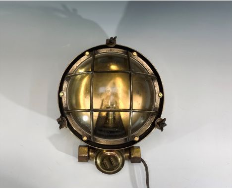 A mid 20th century ship's brass circular bulk head lamp. Diameter 26cm.