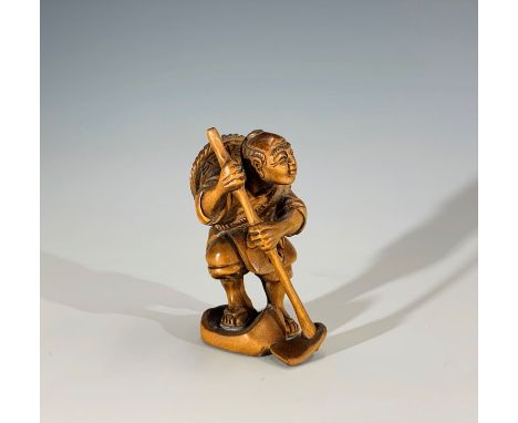 A Japanese carved wood netsuke, signed, height 5.5cm.