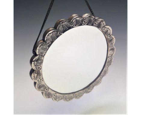 A Middle Eastern ornate lobed silver coloured metal mounted mirror, diameter 18cm