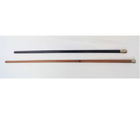 Two hardwood canes with silver tops.