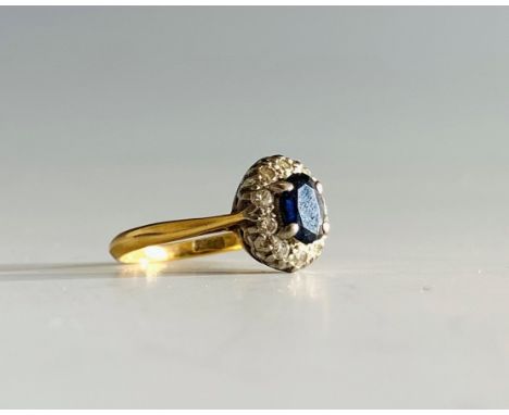 A gold sapphire and diamond oval cluster ring.Condition report: This 18ct gold ring is size K the sapphire&nbsp;measures 6.5m