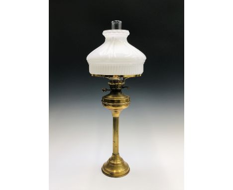 A brass reeded column oil lamp with circular base. Overall height 76cm.
