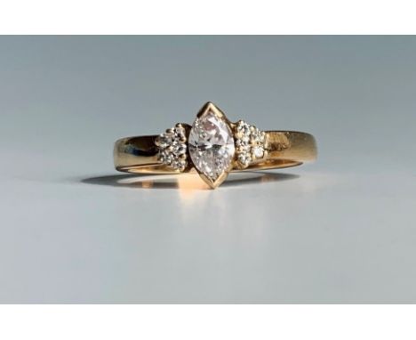 An 18ct gold ring set a navette cut diamond of aproximately 0.25ct flanked by diamond set shouldersCondition report: Size K