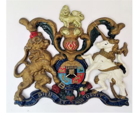 A late 19th/early 20th century cast iron and polychrome painted wall mounted royal coat of arms. Height 40cm, width 44cm.