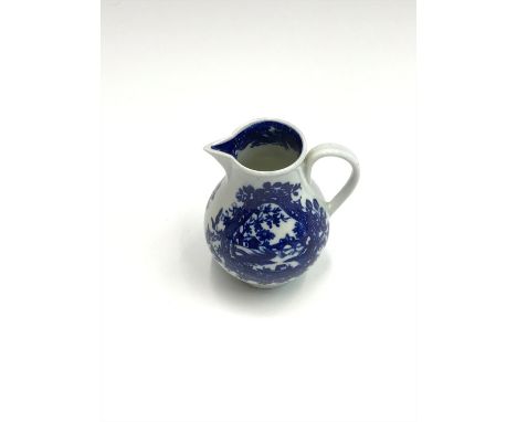An 18th century Worcester sparrow beak blue and white jug, decorated with landscapes with figures and boats within a floral b