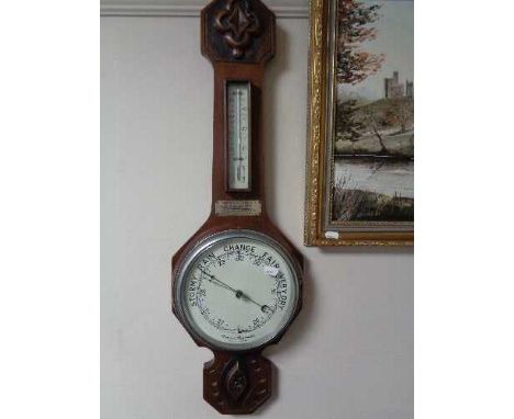 An Edwardian carved mahogany aneroid barometer 