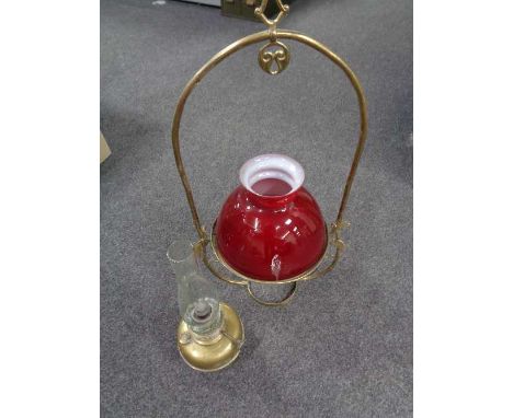 A brass Art Nouveau hanging oil lamp with glass shade and chimney 