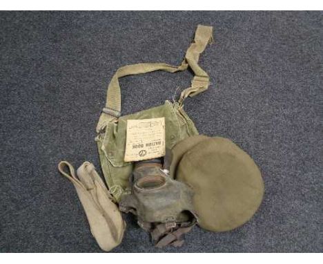 A box of WWII army cap, ration book, gas mask etc 