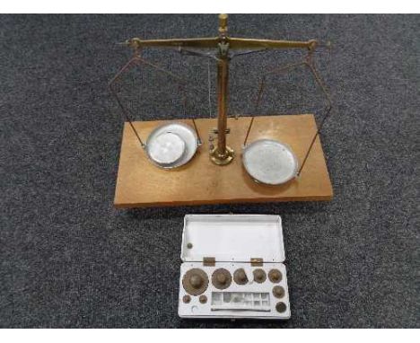 A set of chemist's micro balance scales together with a boxed set of weights 