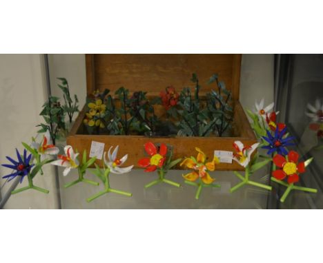 A set of twelve hand blown decorative glass flowers; a set of twelve jade type decorative trees; a set of five hardstone flow