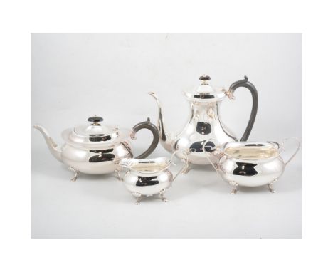 A silver four piece tea/coffee set by Joseph Gloster Ltd , plain polished body on four paw feet, ebony handles and finials to