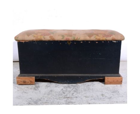 Pine blanket box, upholstered top, raised on block feet, cotton print covers, width 105cm.