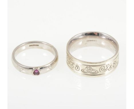 Two gold rings - a 9 carat white gold 8.2mm wide band engraved with a celtic design, ring size U, approximate weight 10.6gms,