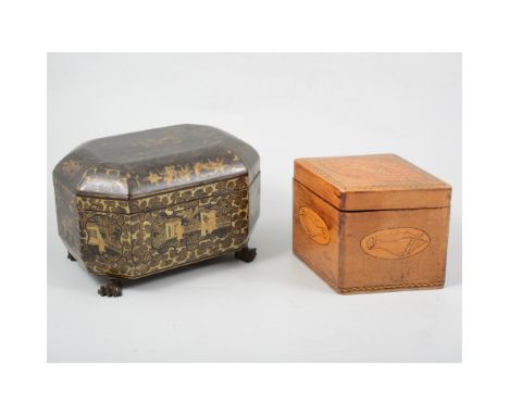 An oriental black lacquer rectangular box with canted corners supported on four claw feet, vignettes depicting figures in a J