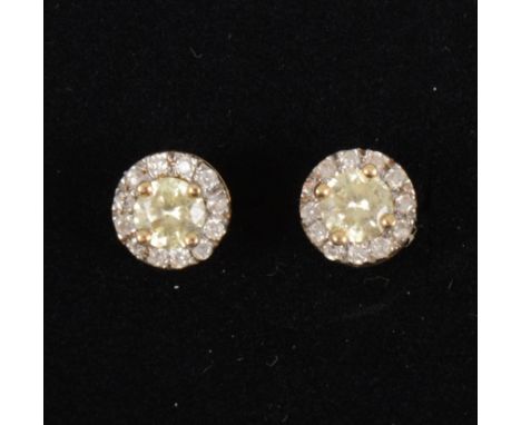 A pair of circular diamond cluster earrings, the centre set with a yellow brilliant cut diamond and surrounded by twelve whit