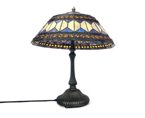 MODERN TIFFANY STYLE LAMP, the circular leaded glass shade above a reeded brass stem and spreading circular foot, 58cm