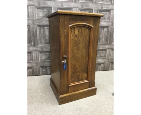 20TH CENTURY OAK BEDSIDE CABINET, of Victorian design, enclosed by a moulded panel door, on a box base, 39cm wide