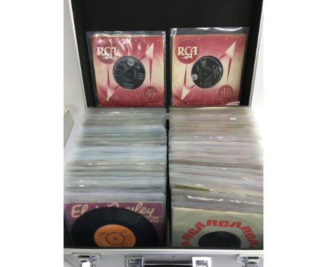 A silver record case containing over one hundred Elvis Presley 7 inch singles including some tri centre RCA pressings.