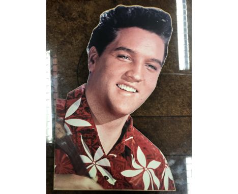 An original Elvis Presley cut out head portrait from the 'Guinness World of Records' exhibition at the Trocadero, Piccadilly 