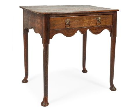 GEORGE II OAK SIDE TABLE 18TH CENTURY the rectangular top over a long frieze drawer with lion mask ring handles, above a shap