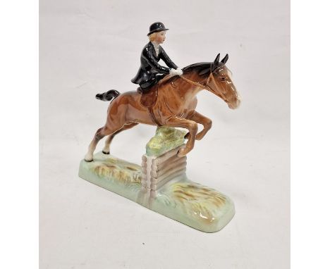 Beswick pottery model of a horse and rider jumping a fence, printed black marks, the female rider sitting side saddle on a ch