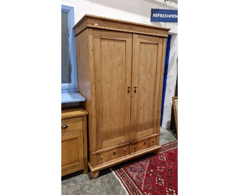 Early 20th century pine wardrobe with pair of cupboards, pair of drawers below, on bun feet, H. 188 x W. 115 x D. 59cmConditi