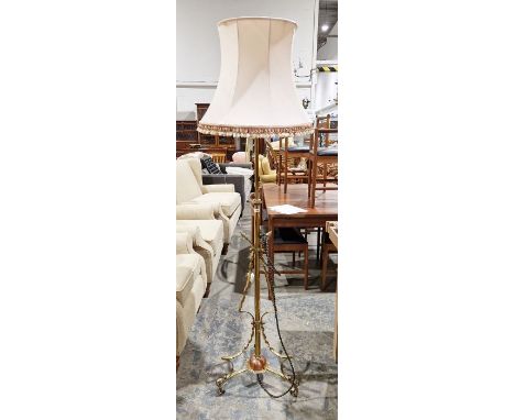 Brass standard lamp on stylised base and pink shade&nbsp;