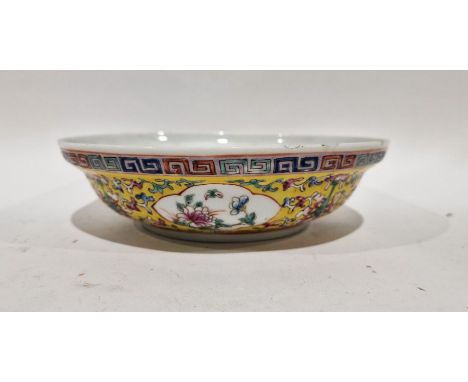 Chinese porcelain shallow dish with everted rim, yellow ground with floral quatrefoil panels, four-character Qianlong mark to