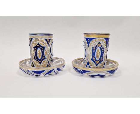 Pair of Bohemian overlay blue and gilt glass beakers&nbsp;on stands, with Arabic script&nbsp;Condition ReportLight surface sc