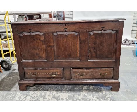 Antique oak mule chest&nbsp;with lift-up lid, having three shaped framed panels to the front, two drawers below, on shaped br