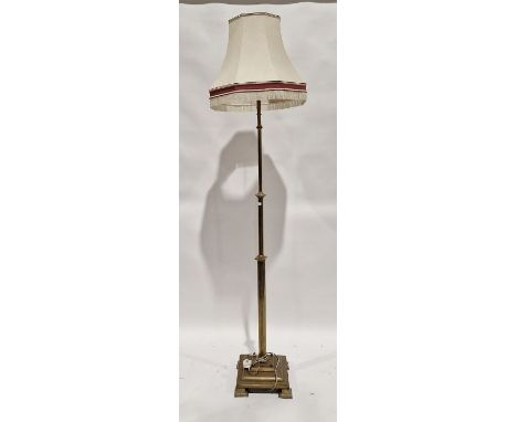 Early 20th century brass standard lamp, with reeded lower section, stepped base raised on square feet with embossed heart dec