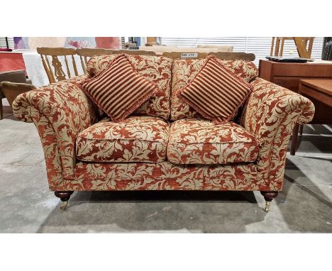 20th century red damask two-seater sofa on turned supports and castors&nbsp;