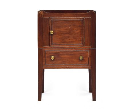 A George III mahogany tray-top bedside commode, late 18th century, the galleried top pierced with two handgrips, above a cupb
